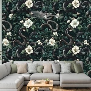 May include: A dark green wallpaper featuring a repeating pattern of black snakes and white flowers. The snakes are entwined with the flowers, creating a sense of movement and mystery. The wallpaper is ideal for adding a touch of elegance and intrigue to any room.