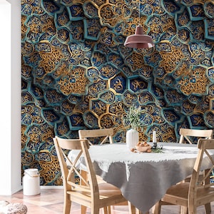 May include: A detailed wall mural with a repeating pattern of gold and teal geometric shapes. The design has a 3D effect, creating depth and texture. The room includes a dining table with wooden chairs and a white tablecloth.
