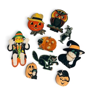 May include: A collection of nine vintage-style Halloween paper die-cut decorations featuring a scarecrow, jack-o'-lanterns, an owl, a skeleton, a black cat, and a witch cat. The colorful illustrations include orange, black, green, and yellow tones.