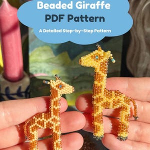 May include: A white ceramic mug with a black handle and the text "But First, Coffee" in a black, handwritten-style font. The mug is on a white surface.