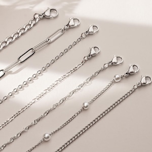 May include: A set of three ceramic mugs with a speckled, matte finish. The mugs are in shades of cream, light gray, and dark gray. Each mug has a simple, modern design and a rounded handle. Perfect for coffee or tea.