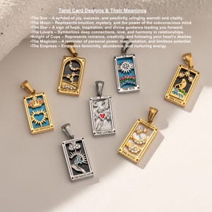 May include: A set of ten gold and silver pendants featuring tarot card designs. Each pendant is a rectangular charm with a different tarot card image, including The Empress, Knight of Cups, The Sun, The Star, The Magician, The Lovers, and The Moon.