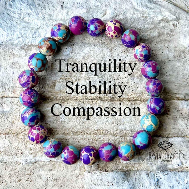 Close-up of the Sea Sediment Jasper bracelet displaying intricate bead patterns with "Tranquility, Stability, Compassion" text overlay. A perfect mindfulness gift.