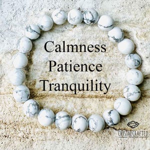 May include: White Howlite beaded bracelet with the words "Calmness, Patience, Tranquility" written on a white background. The bracelet is made by Crystal Crafted Handmade.
