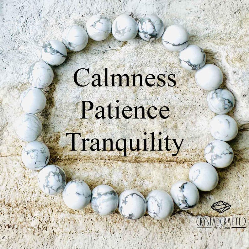 May include: White Howlite beaded bracelet with the words "Calmness, Patience, Tranquility" written on a white background. The bracelet is made by Crystal Crafted Handmade.