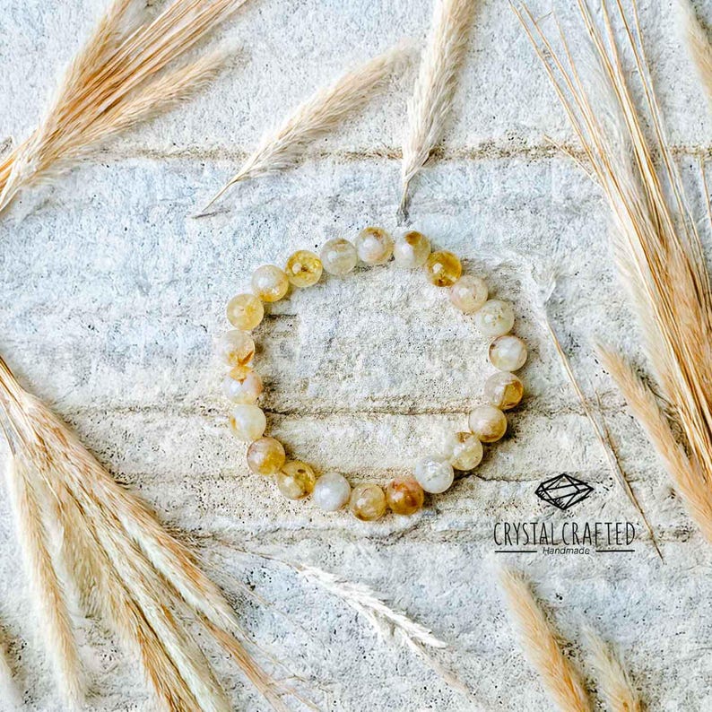 A top-down view of the Citrine bracelet, focusing on the smooth, polished beads in varying shades of yellow and gold.