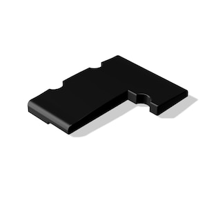 Op de afbeelding: Een zwart, L-vormig object met afgeronde randen en twee gebogen uitsparingen. Het object staat tegen een witte achtergrond en werpt een subtiele schaduw. Het ontwerp is minimalistisch en modern.