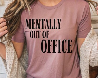 May include: A mauve t-shirt with the text "Mentally Out of Office" printed in black.