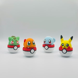 May include: Four colorful Pokémon character figures, including Bulbasaur, Charmander, Squirtle, and Pikachu, each emerging from a red and white Poké Ball. The figures are set against a plain white background.
