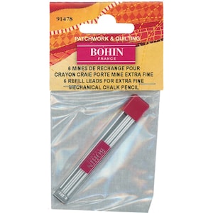 May include: A pack of 6 refill leads for a Bohin mechanical chalk pencil. The leads are extra fine and are packaged in a clear plastic tube with a red cap. The packaging is labelled with the Bohin brand name and the product description in both French and English.