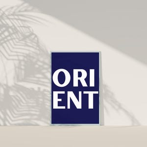 May include: A navy blue poster with the word "ORIENT" printed in white letters.