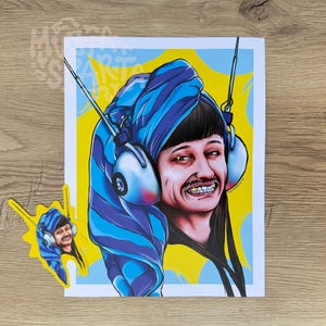 May include: A rectangular art print and a matching die-cut sticker featuring a digital illustration of a person with dark hair wearing a blue and purple striped towel wrap on their head and large white headphones, set against a bright yellow background.