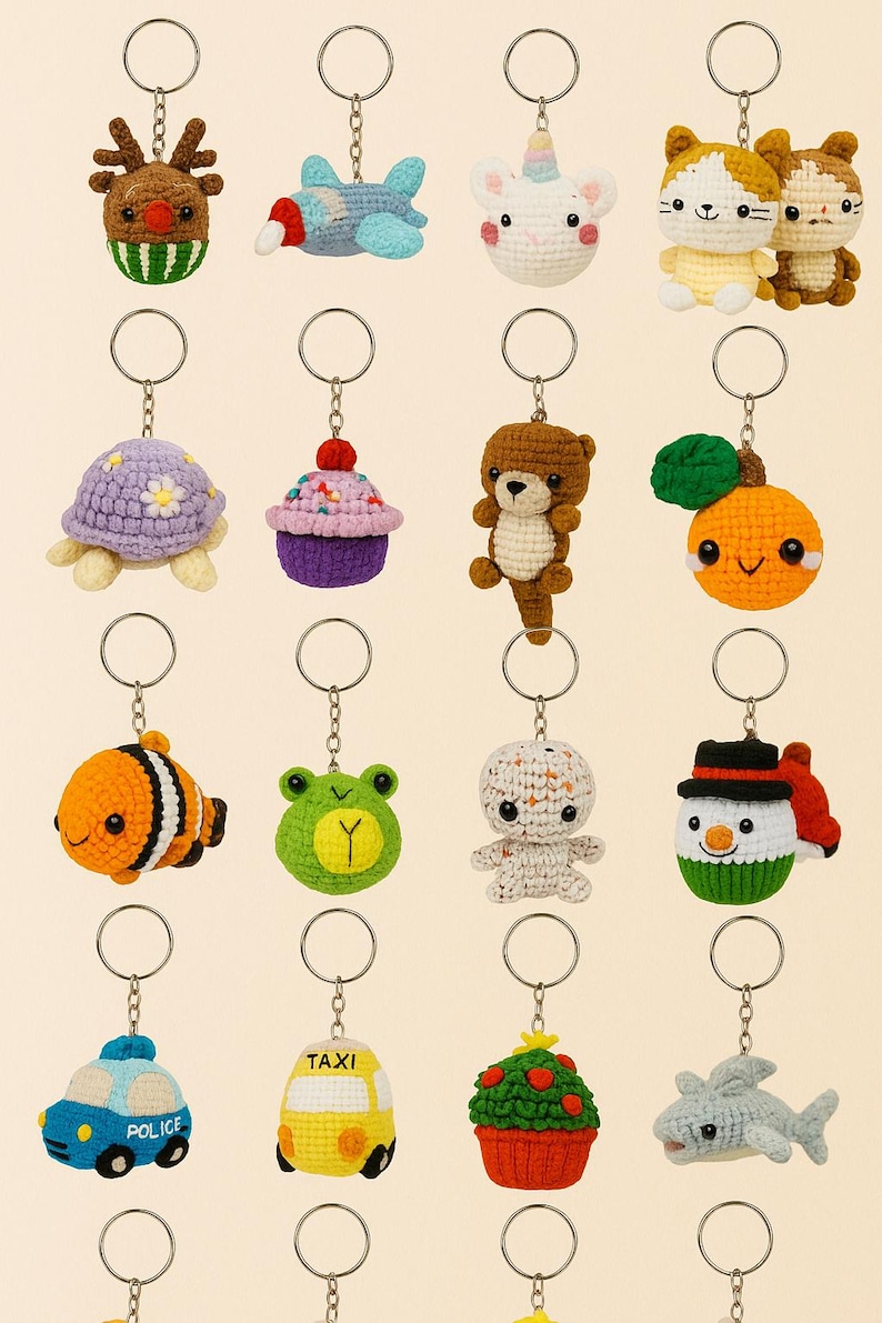 May include: A collection of colorful, crocheted keychains in various shapes, including animals, food, and vehicles. The keychains feature a reindeer, airplane, unicorn, cats, turtle, cupcake, bear, orange, clownfish, frog, snowman, police car, taxi, and shark.
