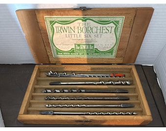 May include: A wooden box set containing six auger bits. The box lid features a green and white label with the text "THE IRWIN BORCHEST LITTLE SIX SET". The bits are arranged in individual slots within the box.