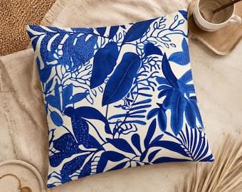 Blue botanical decorative cushion – tropical leaf pattern in blue & cream