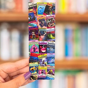 May include: A rectangular bookmark featuring a collage of various Goosebumps book covers by R.L. Stine. The design displays multiple colorful illustrations of horror-themed scenes, including monsters, ghosts, and eerie landscapes, all arranged in a grid pattern.