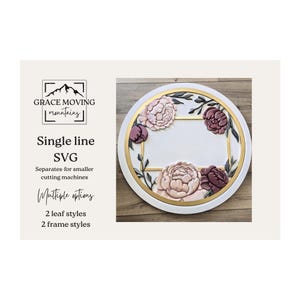 May include: A circular white decorative piece with a gold border and a central gold-framed area. It features embossed peony flowers in pink and burgundy, with green leaves. The text "GRACE MOVING mountains" and "Single line SVG" is also visible.