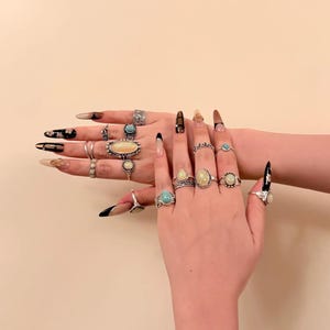 May include: A set of three ceramic mugs with a speckled, matte finish. The mugs are in shades of cream, light gray, and dark gray. Each mug has a simple, minimalist design, perfect for coffee or tea.