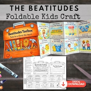 May include: An orange toolbox illustration with the text "Beatitudes Toolbox" and "Tools for a Christ-like Heart". A foldable kids craft with illustrations and text about the Beatitudes is displayed. Crayons and scissors are also visible.