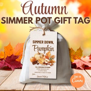 May include: A white bag tied with twine, featuring a gift tag that reads "Simmer Down, Pumpkin." The tag includes a fall-themed illustration with pumpkins, apples, and cinnamon sticks. The background has autumn leaves and the text "Autumn Simmer Pot Gift Tag."