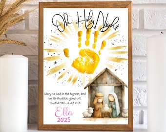 May include: A framed print featuring a golden handprint radiating light, with the text "Oh, Holy Night" above. The image includes a watercolor illustration of a nativity scene and the name "Ella" with the year "2025".