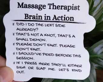 May include: A white sticker with the text "Massage Therapist Brain in Action" and humorous statements about massage therapy, such as "That's not a knot, that's a small demon."