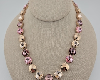 May include: A gold necklace with pink and champagne colored crystal beads.