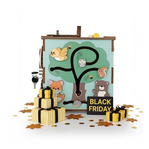 May include: A wooden activity cube with a light blue background and a tree design. The tree features a maze with animal figures like a bird, owl, squirrel, and bear. Includes a key, and gift boxes. The sign says "BLACK FRIDAY".