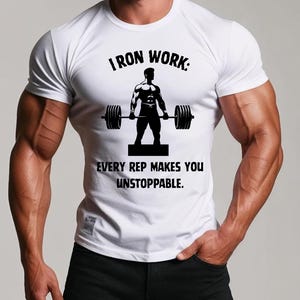 May include: White t-shirt with a black graphic of a person lifting weights. The text on the shirt reads "I Iron Work: Every rep makes you unstoppable."