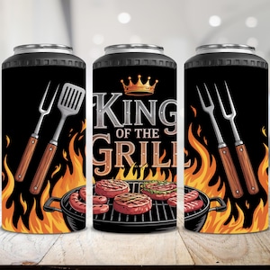 May include: Black tumbler with a grilling theme. The design features a crown, the text "King of the Grill", flames, and images of a grill, spatula, fork, and grilled meats. The tumbler is designed to keep beverages cold or hot.