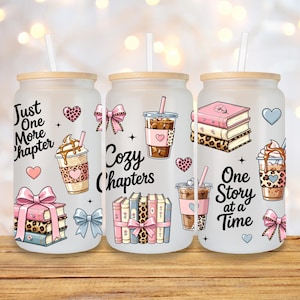 May include: Three frosted glass tumblers with bamboo lids and straws. Each tumbler features a different design with the words "Just One More Chapter", "Cozy Chapters", and "One Story at a Time". The designs include books, hearts, bows, and coffee cups.