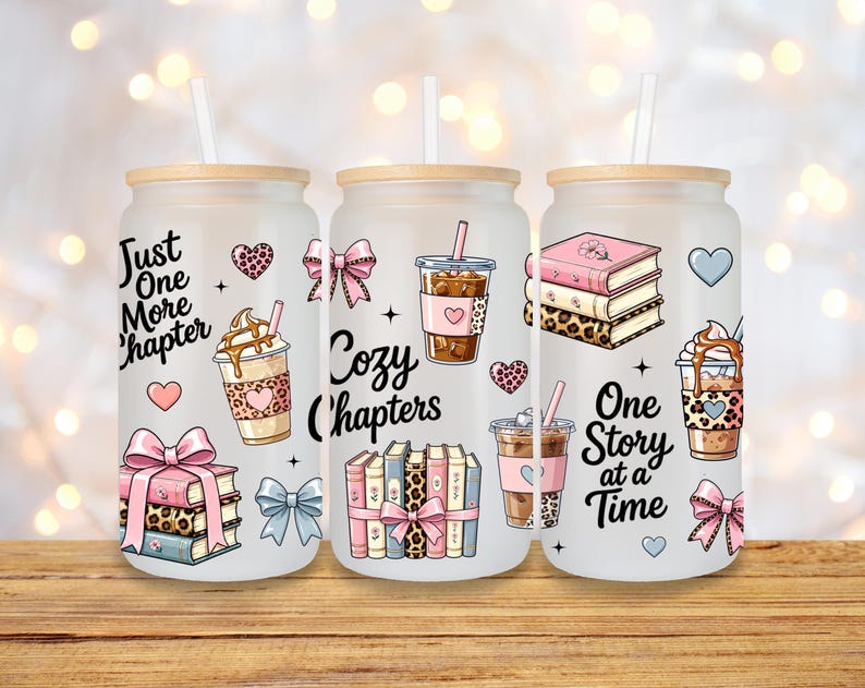 May include: Three frosted glass tumblers with bamboo lids and straws. Each tumbler features a different design with the words "Just One More Chapter", "Cozy Chapters", and "One Story at a Time". The designs include books, hearts, bows, and coffee cups.