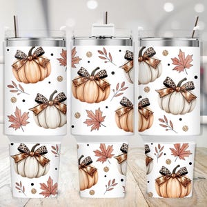 May include: White travel mugs and small tumblers with a fall-themed design. The design features pumpkins with leopard print bows, autumn leaves, and gold glitter dots. The mugs have white handles and lids with a silver straw.