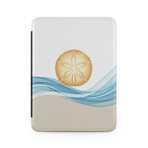 May include: A white rectangular product with a sand dollar design. The design features a tan sand dollar, blue and white waves, and a tan beach scene. The product has a black spine.