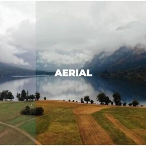 May include: An aerial view of a lake surrounded by mountains and fields. The word "AERIAL" is displayed in white text across the image. The sky is overcast with clouds, and the water reflects the landscape.