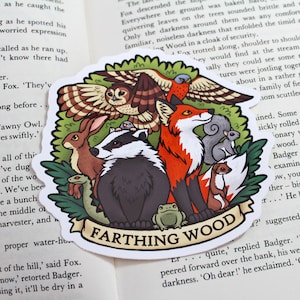 May include: A colourful sticker featuring a badger, fox, owl, rabbit, frog, and weasel. The sticker has a green background with a brown, white, and green border. The text "Farthing Wood" is written in white letters on a brown banner.