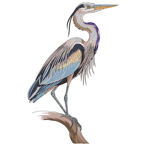 May include: An embroidered design of a Great Blue Heron perched on a branch. The bird features detailed stitching in shades of blue, gray, brown, and yellow. The heron's long neck and beak are prominent, and the design is set against a white background.