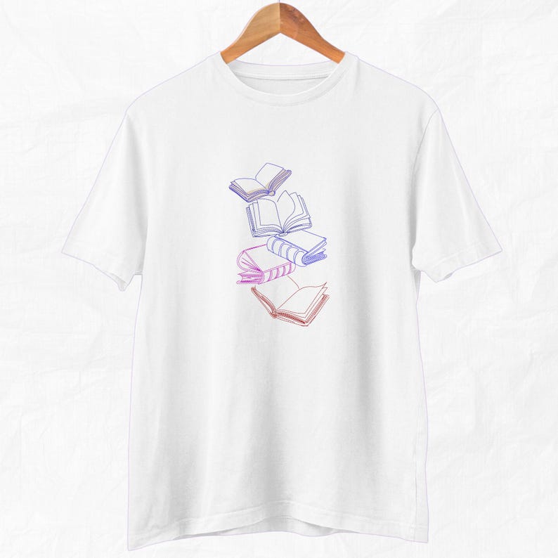 May include: White t-shirt with a graphic of a stack of books in a gradient of pink and blue.
