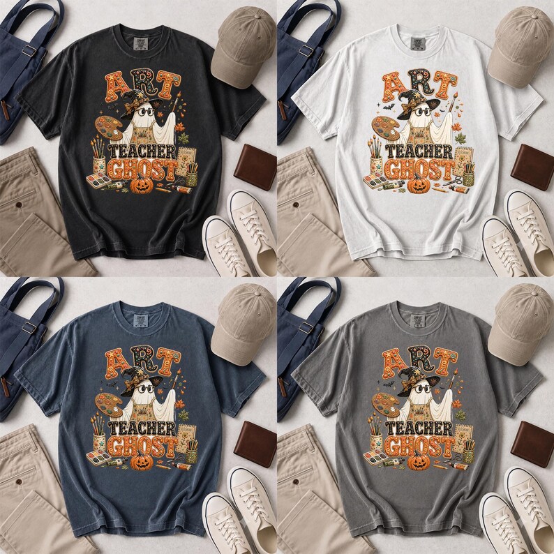May include: Four short-sleeve t-shirts in black, white, blue, and gray, each featuring a graphic of a ghost wearing a witch hat and holding a paintbrush. The design includes a paint palette, pumpkin, and the text ART TEACHER GHOST.