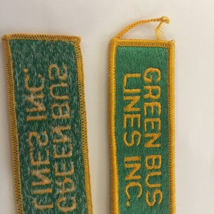 May include: Two green and yellow embroidered patches. The left patch reads "Green Bus Lines Inc." The right patch reads "Green Bus Lines Inc."