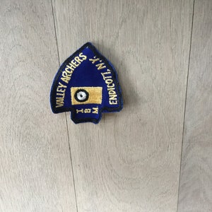 May include: Blue and gold embroidered patch with the text "Valley Archers" and "Endicott, N.Y."  The patch features a target with a bullseye.