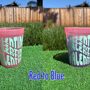 May include: A color-changing plastic cup that transitions from red to blue, featuring the name Valentina repeated in a wavy, stacked light green font. The text Red to Blue is printed at the bottom of the image, highlighting the color shift.