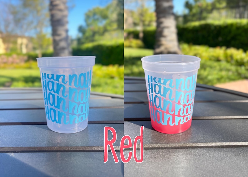 May include: A clear plastic cup featuring the name Hannah repeated in a repeating teal blue font pattern. The cup is shown empty on the left and filled with a red liquid on the right, with the word Red written in pink below the cups.