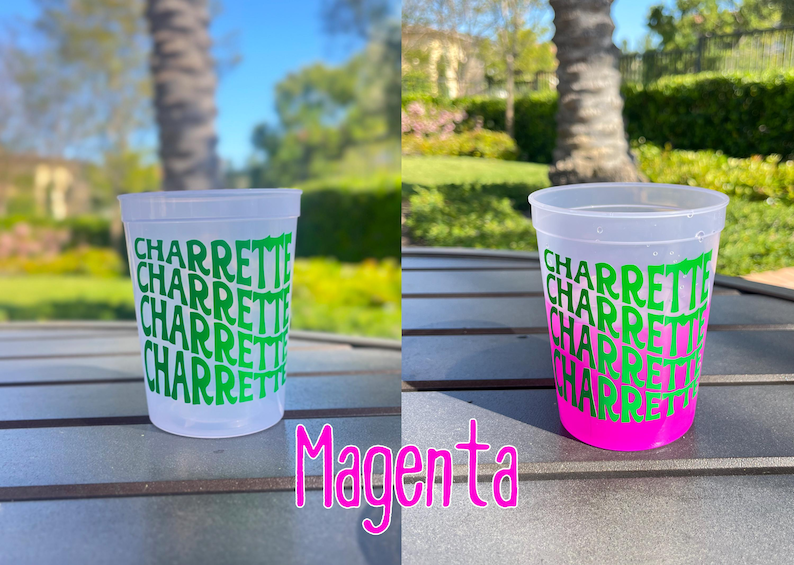 May include: A translucent plastic stadium cup featuring the word CHARRETTE repeated five times in a wavy, stacked green font. The cup on the right shows a vibrant magenta color change at the base, while the cup on the left remains clear.