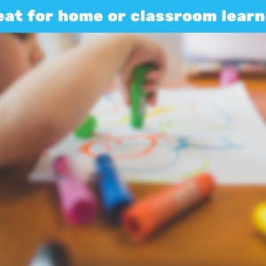 May include: A child's hand is holding a green crayon over a white paper with colorful drawings. Several crayons in pink, blue, orange, and yellow are scattered on a wooden table. The text "Great for home or classroom learning" is in a blue banner.