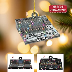 May include: A 2D flat ornament shaped like a sound mixing console, with the name "ANDREW" on it. The ornament has a silver and black color scheme with colorful lights. Additional ornaments are shown below.