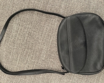 May include: A black leather shoulder bag with a flap closure and a small logo on the front.