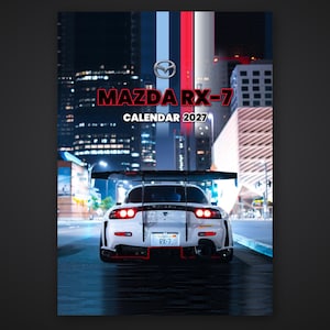 May include: A 2027 wall calendar featuring a white Mazda RX-7 sports car with a large rear wing, red accents, and a license plate reading RX-7. The text MAZDA RX-7 CALENDAR 2027 is printed above the car against a city night background.