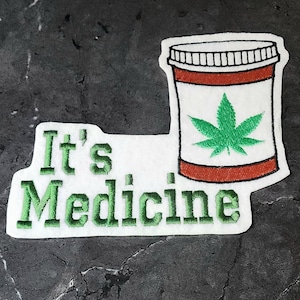 May include: White embroidered patch with green text that reads "It's Medicine" and a green marijuana leaf inside a red and white pill bottle.