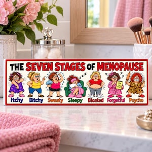 Funny Seven Stages of Menopause 16×5 rigid PVC sign displayed on a bright bathroom vanity with colorful cartoon characters.